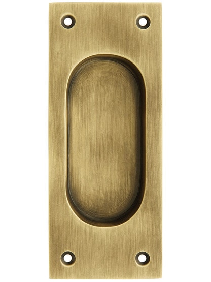 Rectangular Pocket Door Pull in Antique Brass.